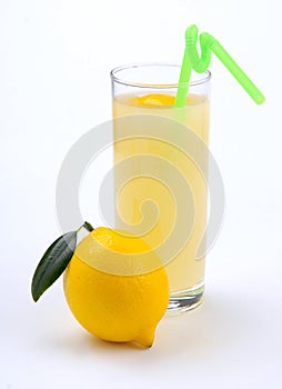 Lemon juice in a glass and an lemo