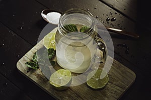 Lemon juice. Lemon juice in a glass. Place on a dark wooden floor