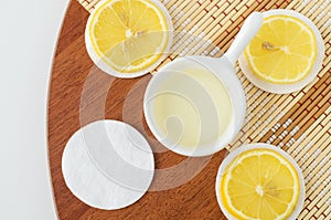 Lemon juice, lemon slices and cotton pads. Ingredients for preparing homemade hair mask, hair dye or face toner.