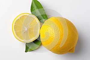 Lemon and a leaf resting on a plain white surface. Close-Up View of a Freshly Sliced and Whole Lemon on a White Background