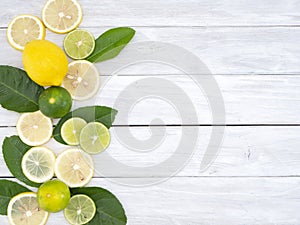 Lemon with leaves on white wooden
