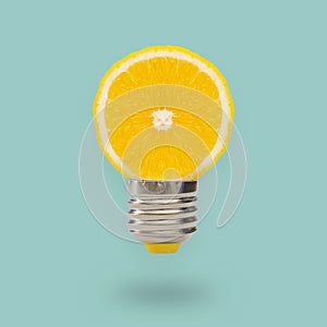 Lemon light bulb on bright blue background. Summer fun concept.