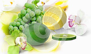 Lemon lime grape orange and ananas with  orchids flowers but on blue  white yellow background fruite leaves  berry  copy space tem