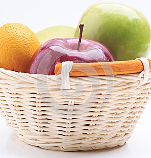 Lemon mango apple in the basket isolated on white background