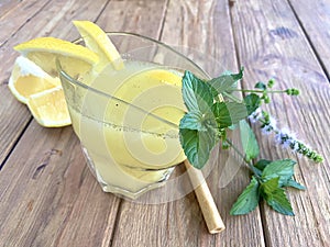 Lemon and mint limonade on the wooden table.