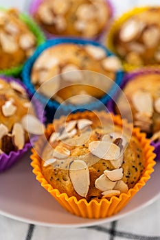 Lemon poppy seed muffins garnished with almond slivers