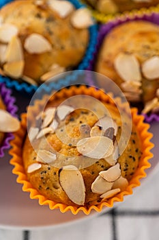 Lemon poppy seed muffins garnished with almond slivers