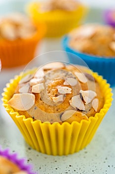 Lemon poppy seed muffins garnished with almond slivers