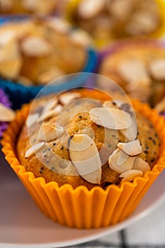 Lemon poppy seed muffins garnished with almond slivers