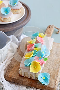 Lemon and poppy seeds loaf cake decorated with pastel fondant flowers