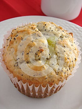 Lemon poppyseed muffin on white plate