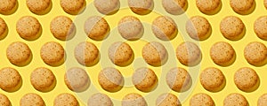 Lemon protein Cookies with almond in pattern on the yellow background. No sugar. Top view. Healthy and tasty. Continous pattern,