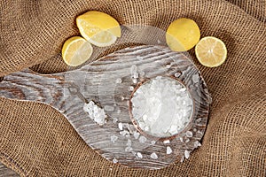 Lemon salt or Citric acid on wood background. Citric acid or lemon salt in wooden bowl. Lemon salt for cooking on wooden