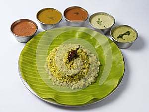 Lemon Sevai with onion in a banana leaf served with sambar and chutneys an traditional Indian Cuisine