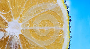 Lemon slice in Bubbly Water on blue background