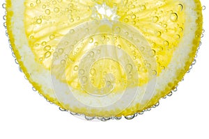 Lemon Slice in Clear Fizzy Water Bubble Background photo