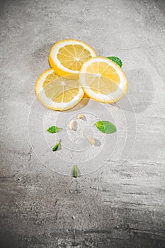 Lemon slice on gray table. Fresh citrous fruits piece,  with copyspace photo