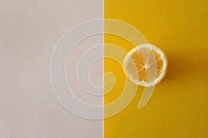 Lemon slice on yellow and white background