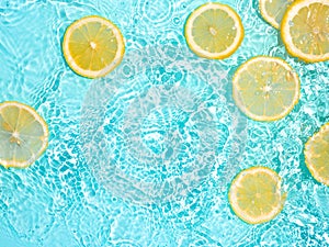 Lemon slices in clean transparent water, blue bg