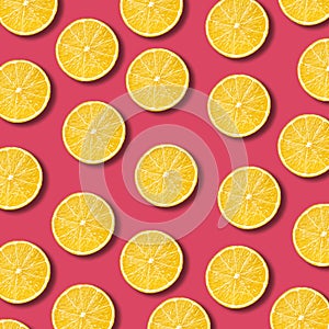 Lemon slices pattern on vibrant pomegranate color background