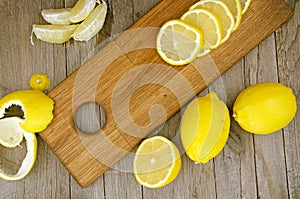 Lemon slices and segments on wooden board