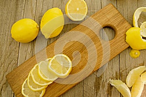 Lemon slices and segments on wooden board