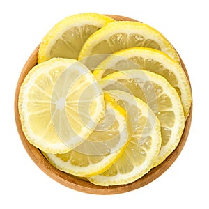 Lemon slices in wooden bowl over white