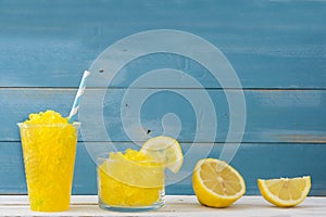 Lemon slushies in glass on rustic wood