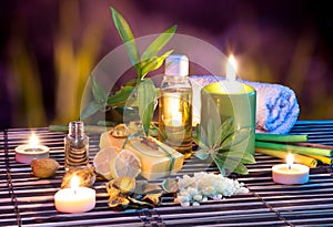 Lemon soap , oil, towel, salt, bamboo, and candles in garden