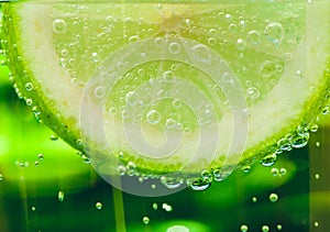 Lemon in sparcle water drops