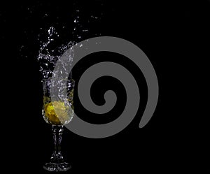 Lemon splashing into clear water on Black background, splash