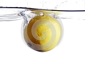 Lemon splashing into water