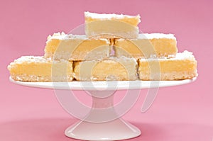 Lemon squares on a white cake stand