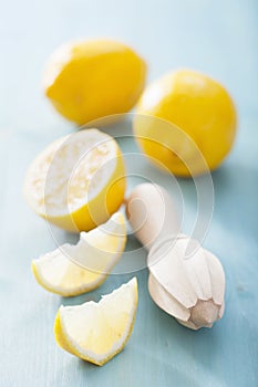 Lemon and squeezer over blue background