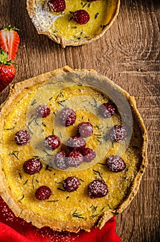 Lemon tart with rosemary and berries