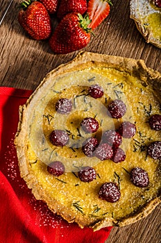 Lemon tart with rosemary and berries