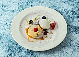 lemon tart with strawberry and blackberry served in plate isolated on background top view of italian food