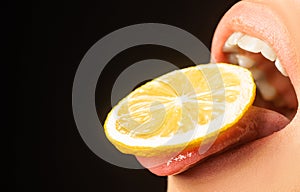 Lemon taste. Lemon slice on womans tongue. Open mouth with sour taste. Cocktail in the summer. Open woman mouth with