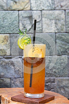 Lemon tea coffee cooler of ice on glass on wood and marble background