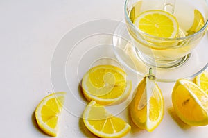 Lemon tea in a transparent cup on white background