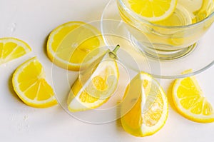 Lemon tea in a transparent cup on white background