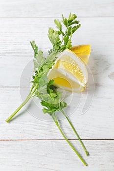 Lemon with vegetables seen from above on wooden background