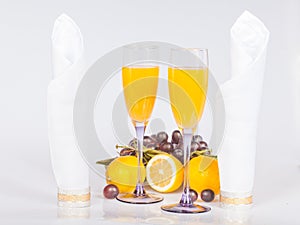 Lemon, wine glass with juice and grapes