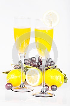 Lemon, wine glass with juice and grapes