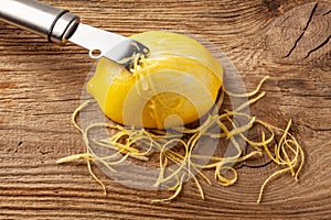 Lemon zest and Zester on wooden board