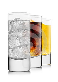 Lemonade drink with cola and orange soda with ice cubes on white background in highball glasses