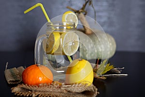 Lemonade drink in glass jar with sliced lemon slices on desk