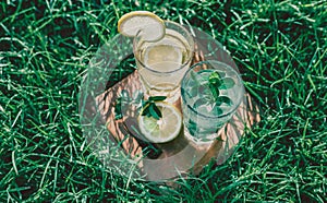 Lemonade in a glass on green grass