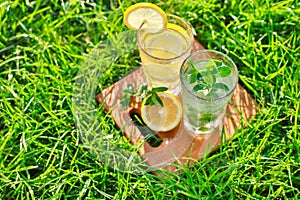 Lemonade in a glass on green grass