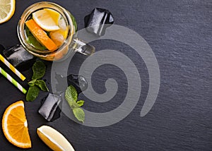 Lemonade in a glass jar on the black background